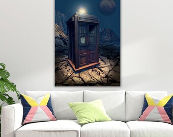 May include: A rectangular blue police box stands on a cracked, rocky landscape under a dark sky with a large moon. The structure features a glowing light on top, paneled sides, and a small sign on the door. The scene is rendered in a dark, atmospheric style.