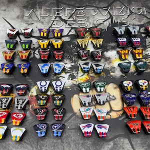 May include: A collection of NFL team logo helmet decals. The decals are in various colors and feature logos for teams such as the Patriots, Cowboys, Steelers, and more.