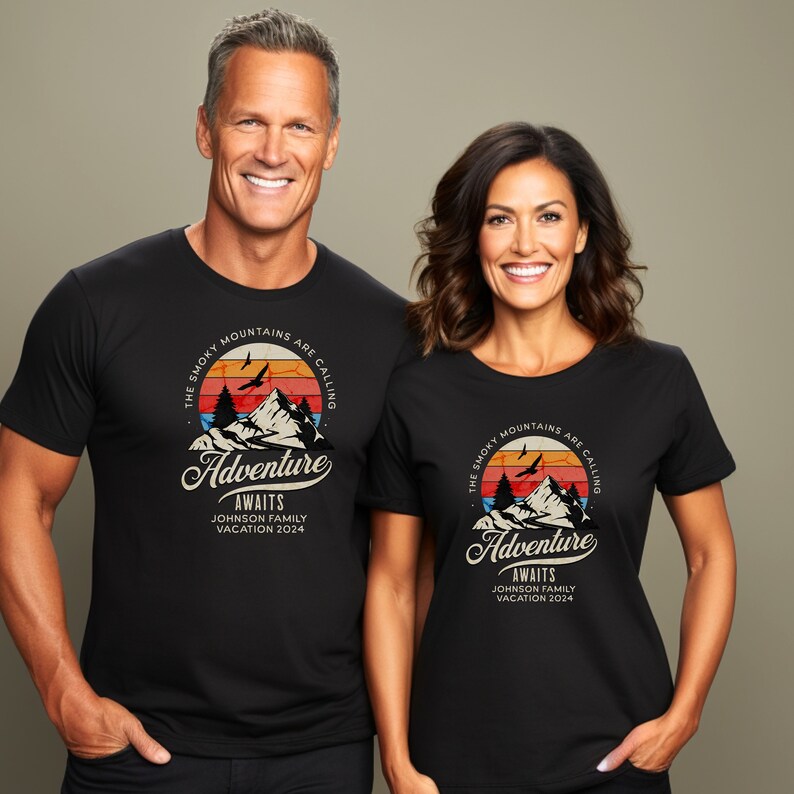 May include: Black t-shirts with a mountain graphic and the text "The Smoky Mountains Are Calling Adventure Awaits Johnson Family Vacation 2024." The graphic features a mountain range, trees, birds, and a sunset.