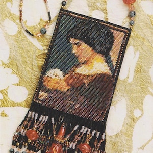 May include: A beaded necklace with a black beaded bag featuring a portrait of a woman holding a white flower. The bag has a fringe of beads in shades of red, black, and gold.