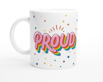 May include: White ceramic mug with a rainbow-colored "PROUD" graphic in pink letters. The graphic is surrounded by colorful confetti.