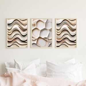 May include: Three abstract art prints with a wavy, organic, and textured design in shades of beige, brown, and white.