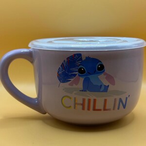 May include: A lavender ceramic soup bowl with a matching lid and handle. The bowl features a cartoon image of Stitch from Lilo & Stitch, with the word "CHILLIN'" in colorful letters.