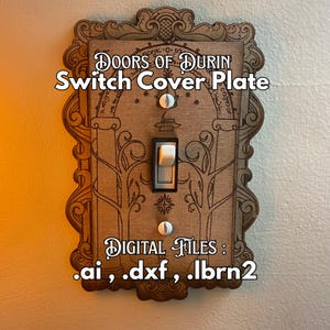 May include: Wooden switch cover plate with the text "DOORS OF DURIN Switch Cover Plate". The plate has an ornate, carved border and features a light switch. The text "DIGITAL FILES: .ai, .dxf, .lbrn2" is also visible.