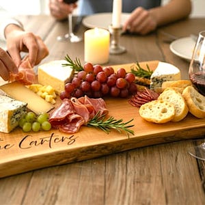 Live edge Charcuterie board in use with wine and food, perfect bridal shower gift, housewarming gift, or entertaining board.