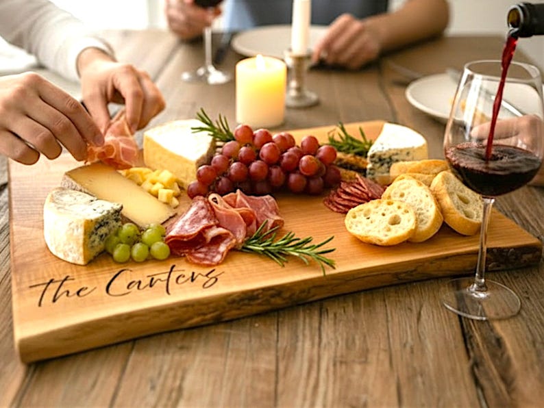 Live edge Charcuterie board in use with wine and food, perfect bridal shower gift, housewarming gift, or entertaining board.