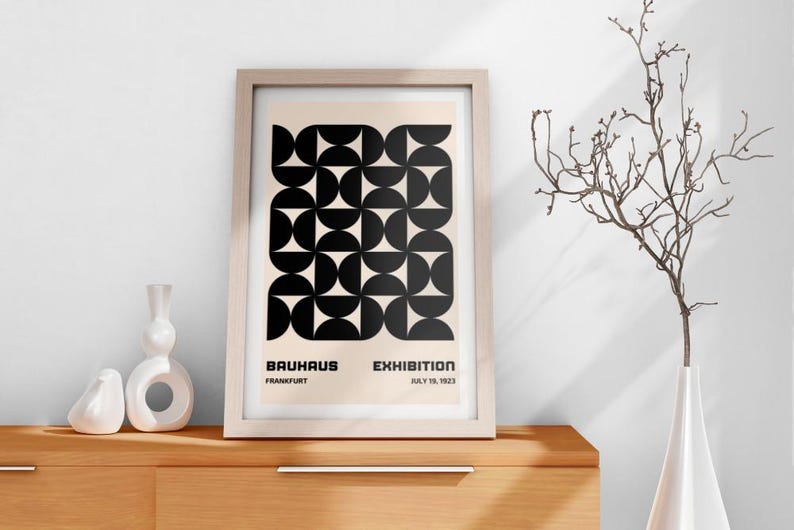 May include: A framed black and white geometric print with the text "Bauhaus Exhibition Frankfurt July 16, 1923".