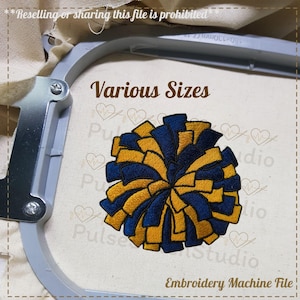 May include: An embroidered pom-pom design in navy blue and gold, displayed within an embroidery hoop. The text "Various Sizes" is above the pom-pom. The words "Embroidery Machine File" are at the bottom. The text "Reselling or sharing this file is prohibited" is at the top.