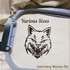 May include: Embroidery machine file of a snarling wildcat head in brown on a beige fabric background. The text "Various Sizes" and "Stitch Studio" is visible in brown.