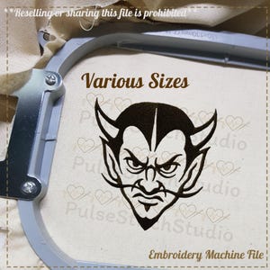May include: A black devil face embroidery design with horns, a goatee, and an angry expression. The text "Various Sizes" is above the design, and "Embroidery Machine File" is below. The design is in an embroidery hoop.