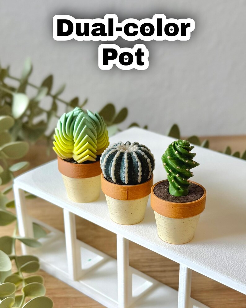 May include: Three miniature potted plants featuring textured green and yellow cacti in small, dual-color pots with a tan rim and speckled cream base. The text "Dual-color Pot" appears at the top of the image above the three small decorative plants.