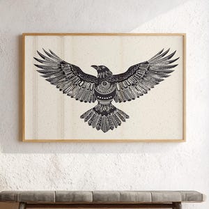 Tribal raven wall art print in black and white featuring a detailed geometric bird design with outstretched wings, framed against an off-white background.