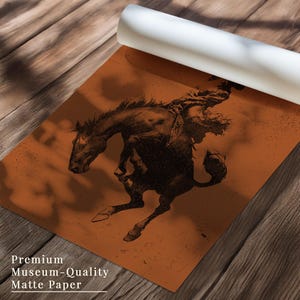 May include: A rolled-up matte paper print featuring a black and brown illustration of a cowboy riding a bucking bronco. The print has the text "Premium Museum-Quality Matte Paper" at the bottom.