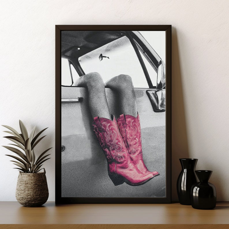 May include: A black and white photograph of a person's legs sticking out of a car window. The person is wearing pink cowboy boots.