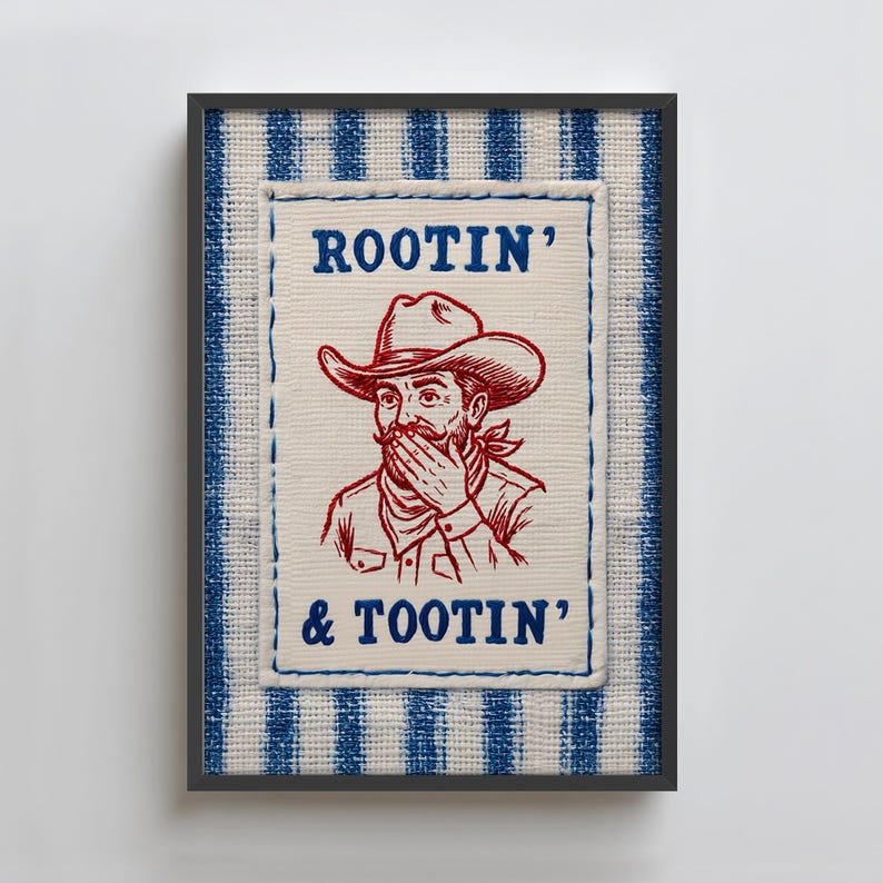Może przedstawiać: Oprawiona grafika z czerwoną i niebieską ilustracją kowboja z napisem "ROOTIN' & TOOTIN'". Kowboj ma na sobie kapelusz i zakrywa usta. Rama ma niebiesko-biały wz&oacute;r w paski.