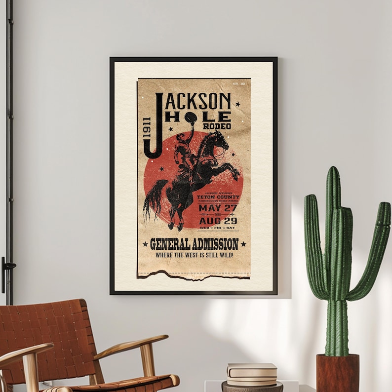 May include: A vintage style poster advertising the Jackson Hole Rodeo in Teton County. The poster features a red circle with a cowboy riding a bucking horse. The text on the poster reads '1911 Jackson Hole Rodeo Teton County May 27 Aug 29 * General Admission * Where the West is Still Wild!'