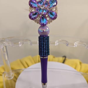 Purple bead pen with spinning flower focal bead and smaller focal bead.