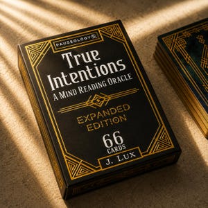 May include: A black deck of cards box titled True Intentions A Mind Reading Oracle Expanded Edition with 66 cards by J. Lux. The box features gold geometric line art borders and text on the front, with a partial stack of cards visible to the right.