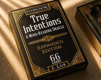 May include: A black deck of cards box titled True Intentions A Mind Reading Oracle Expanded Edition with 66 cards by J. Lux. The box features gold geometric line art borders and text on the front, with a partial stack of cards visible to the right.