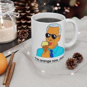 May include: White ceramic mug with a cartoon illustration of a person wearing sunglasses and eating ice cream. The text "I'm orange now, Jack." is printed on the mug.