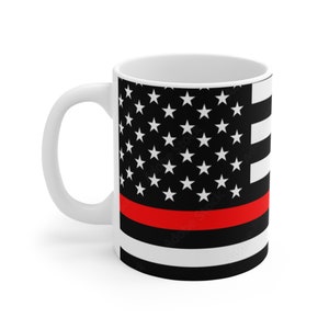 May include: White ceramic coffee mug with a black and white American flag design with a red stripe across the middle.