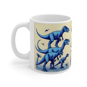 May include: White ceramic mug with a blue and white illustration of four dinosaurs. The dinosaurs are in different sizes and are arranged in a stacked formation. The background is a light beige color.