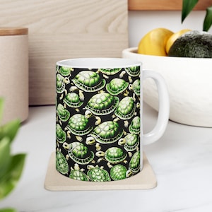 May include: White ceramic mug with a black background and a repeating pattern of green turtles.