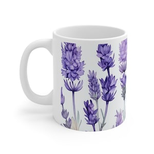 May include: White ceramic mug with a lavender floral pattern. The mug features a repeating design of purple lavender flowers with green stems and leaves on a white background.