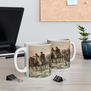 May include: Two white ceramic mugs with a scene of men on horseback in a snowy landscape. The mugs are printed with a painting of a historical event, possibly a battle or military campaign. The scene is set in a wintery environment with snow on the ground and trees in the background.