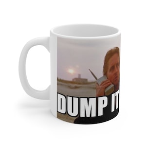 May include: White ceramic mug with a photo of a man holding a large, old-fashioned cell phone. The text "DUMP IT" is printed in black at the bottom of the mug.