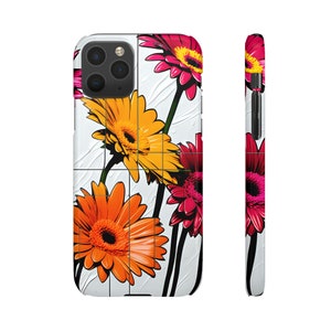 May include: A white iPhone case with a colorful floral design. The flowers are orange, yellow, and pink. The case has a white background with a grid pattern.