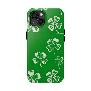 May include: Green phone case with a white four-leaf clover pattern.