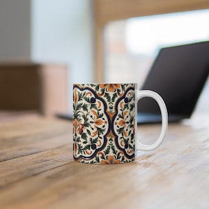 May include: White ceramic mug with a colorful floral pattern in shades of blue, green, orange, and yellow. The pattern is reminiscent of traditional tile designs.