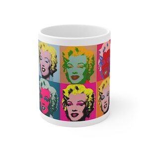 Könnte beinhalten: Weiße Keramiktasse mit einem Pop-Art-Design, das ein sich wiederholendes Bild von Marilyn Monroes Gesicht in verschiedenen Farben zeigt. Die Tasse hat einen weißen Hintergrund und das Bild ist auf der Vorderseite aufgedruckt.