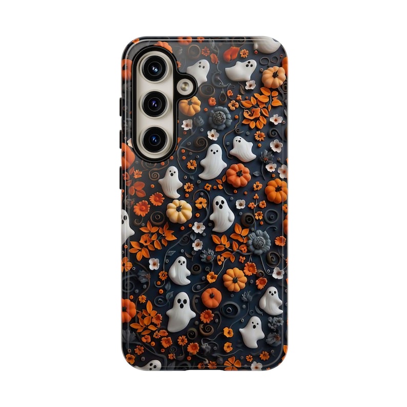 May include: A phone case with a Halloween theme. The case features a dark blue background with white ghosts, orange pumpkins, and orange leaves. The case has a glossy finish and a camera cutout.
