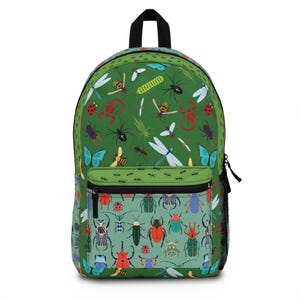May include: Green backpack with a colorful insect pattern. The design features various bugs, including butterflies, dragonflies, and beetles. The backpack has a black handle, a front pocket, and a side mesh pocket.