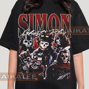 May include: Black t-shirt with a graphic print of a group of people wearing skull masks. The text "SIMON Ghost Riley" is printed in red and white on the shirt.