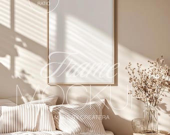 May include: A beige bedroom with a large, framed picture hanging on the wall above a bed with striped pillows and a beige blanket. A small side table with a vase of dried flowers and a glass jar sits next to the bed.