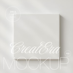 Puede incluir: Maqueta de lienzo cuadrada y blanca con el texto "Create Era MOCKUP" en una fuente cursiva delicada. La imagen incluye un gráfico "DIN A FRAME RATIO" y un gráfico "PSD", todo en un estilo minimalista.
