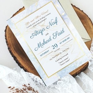 May include: A wedding invitation with a blue and white marble background and gold accents. The invitation reads "Mr. and Mrs. Hanif cordially invite you to the wedding ceremony of their beloved daughter Atiga Naif with Mohad Said Saturday, December 29 at 10:00 AM 123 Anywhere St., Any City Looking Forward *insert name* *insert name*"