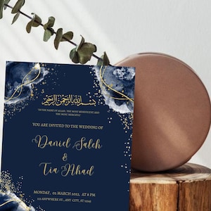 May include: A navy blue wedding invitation with gold calligraphy and a watercolor design. The invitation reads "بسم الله الرحمن الرحيم" "In the name of Allah, the Most Beneficent and the Most Merciful." "You are invited to the wedding of Daniel Salch & Tia Ahad" "Monday, 02 March 2023, at 8 PM" "123 Anywhere St., Any City, ST 12345"