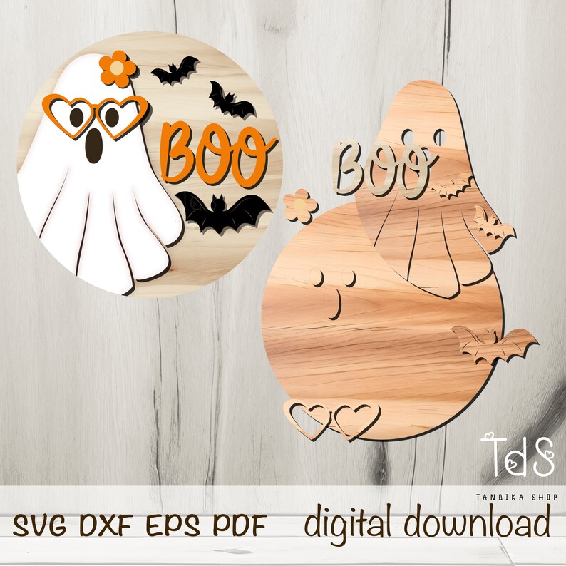 May include: Two round wooden signs with a ghost and the word "BOO" on them. The ghost has heart-shaped sunglasses and a flower on its head. The signs are perfect for Halloween decorations.