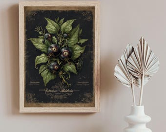 May include: A framed art print featuring a dark background with a botanical illustration. The artwork depicts a cluster of dark purple berries with eye-like features, surrounded by green leaves. The frame is a light wood color, and the print has text at the bottom.