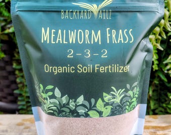 May include: A dark green stand-up pouch of Backyard Ailz Mealworm Frass 2-3-2 organic soil fertilizer. The bag features a bird logo, white text, and a botanical leaf graphic at the bottom. The net weight is clearly printed as 12 oz (340 g).