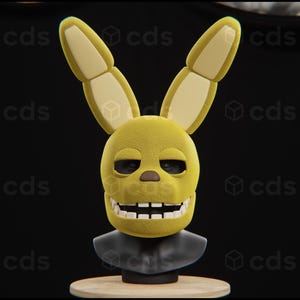 May include: A yellow plush bunny rabbit head with black eyes and a wide smile. The head is mounted on a black stand.