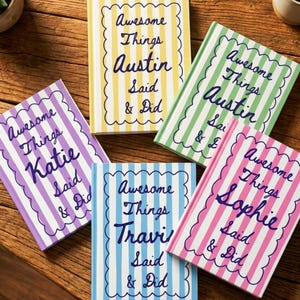 May include: A collection of colorful notebooks with striped covers and scalloped borders. Each notebook features the phrase "Awesome Things" followed by a name and "Said & Did" in a handwritten style. The notebooks are in various colors.