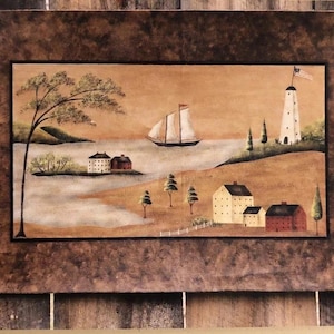 May include: A framed painting depicting a coastal scene with a sailboat, lighthouse, and several buildings. The artwork features a brown border and a muted color palette of beige, brown, and white, evoking a rustic aesthetic.
