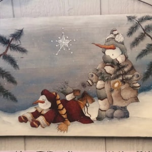 May include: A winter scene painting featuring two snowmen in a snowy landscape. One snowman is wearing a brown and red scarf and hat, while the other is wearing a gray and white scarf and hat. A white star is in the sky above the snowmen.