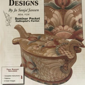 May include: A Folk Art Designs seminar packet by Jo Sonja Jansen. The image shows a decorative wooden box with a bird-like design, featuring intricate floral patterns in shades of brown, red, and green. The text includes "Seminar Packet Hallingdal's Partlet".