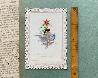 An antique French prayer card, lacy card, forget me nots, pansies, doves